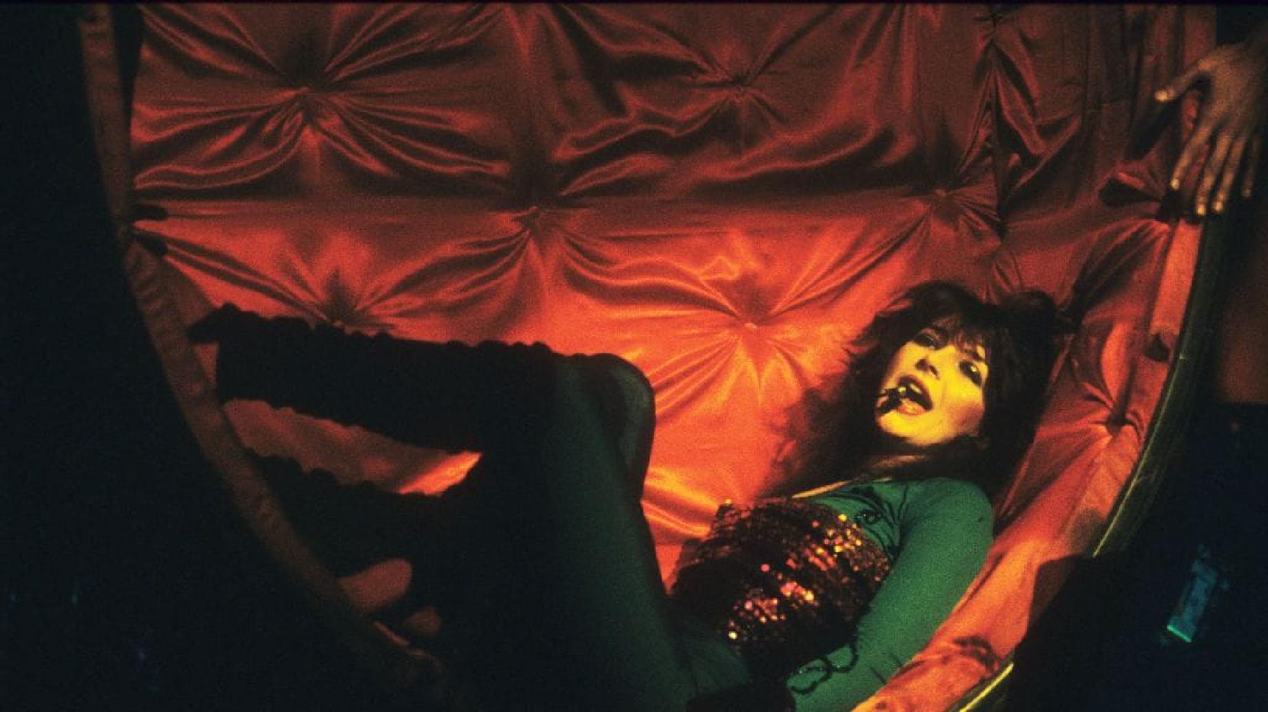 Kate bush performing in a red chair