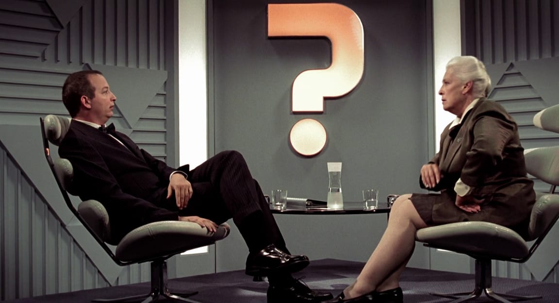 A man and woman conversing on a TV show