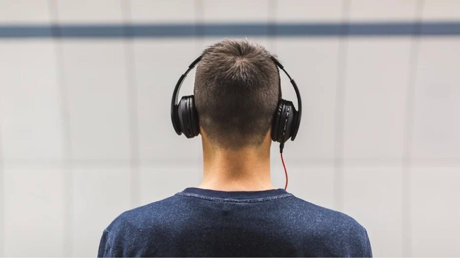 View from the back of a man wearing headphones