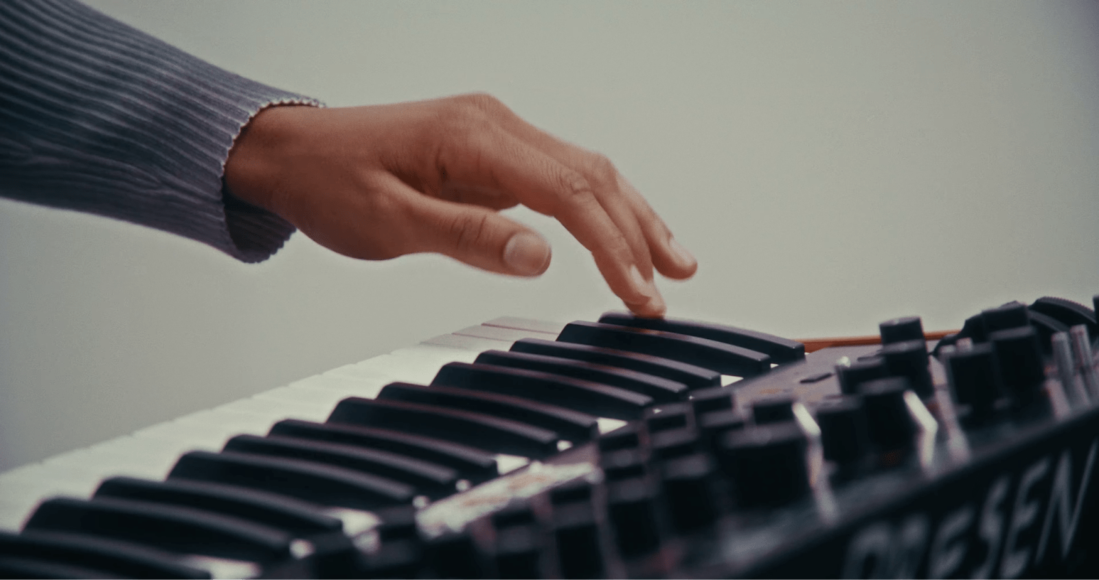 Musician’s hand playing on a keyboard