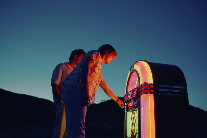 2 people using a jukebox in the outside