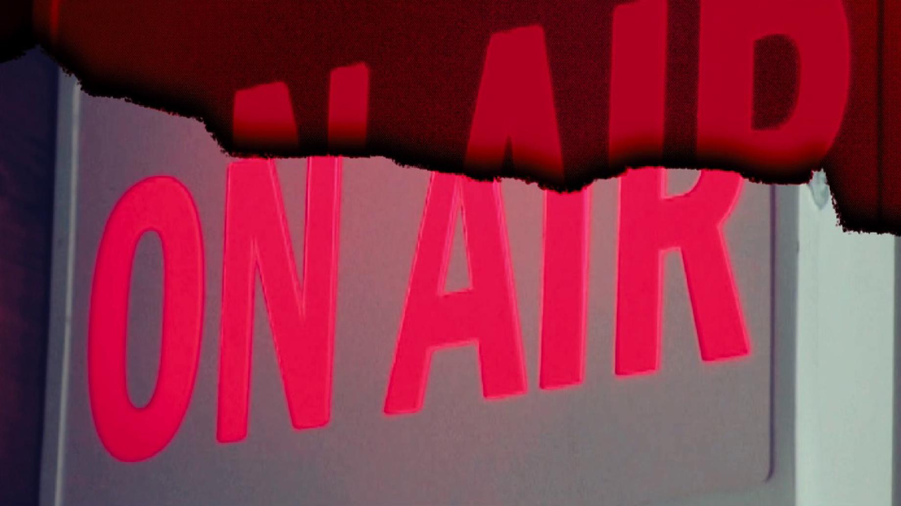 On Air sign lit up in a podcast studio