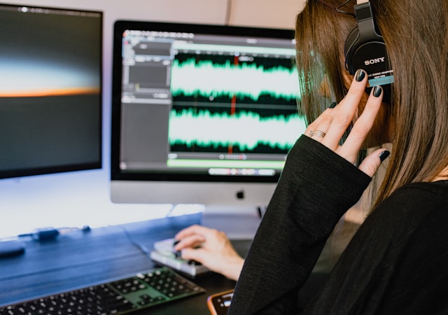 Lady trimming audio on a computer