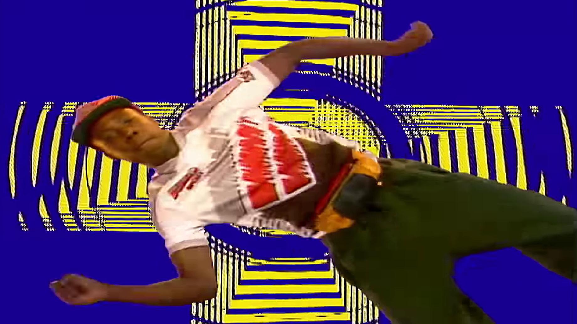 Man dancing on a blue and yellow background.